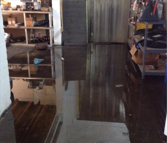 Standing water in a garage due to storm damage